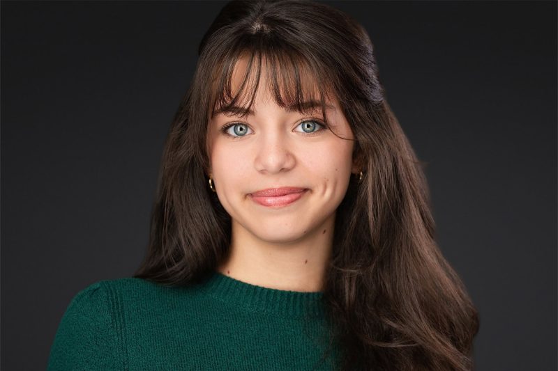 A captivating actor headshot of a woman in a green top, demonstrating the range and coaching provided in a full individual session in Lakeland by James Connell.