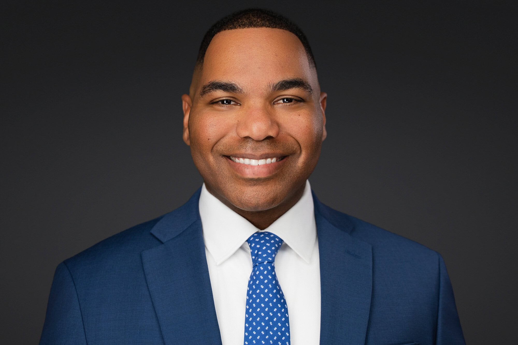 Professional executive headshot of a man in a blue suit taken at a Headshot Booth Lakeland event.
