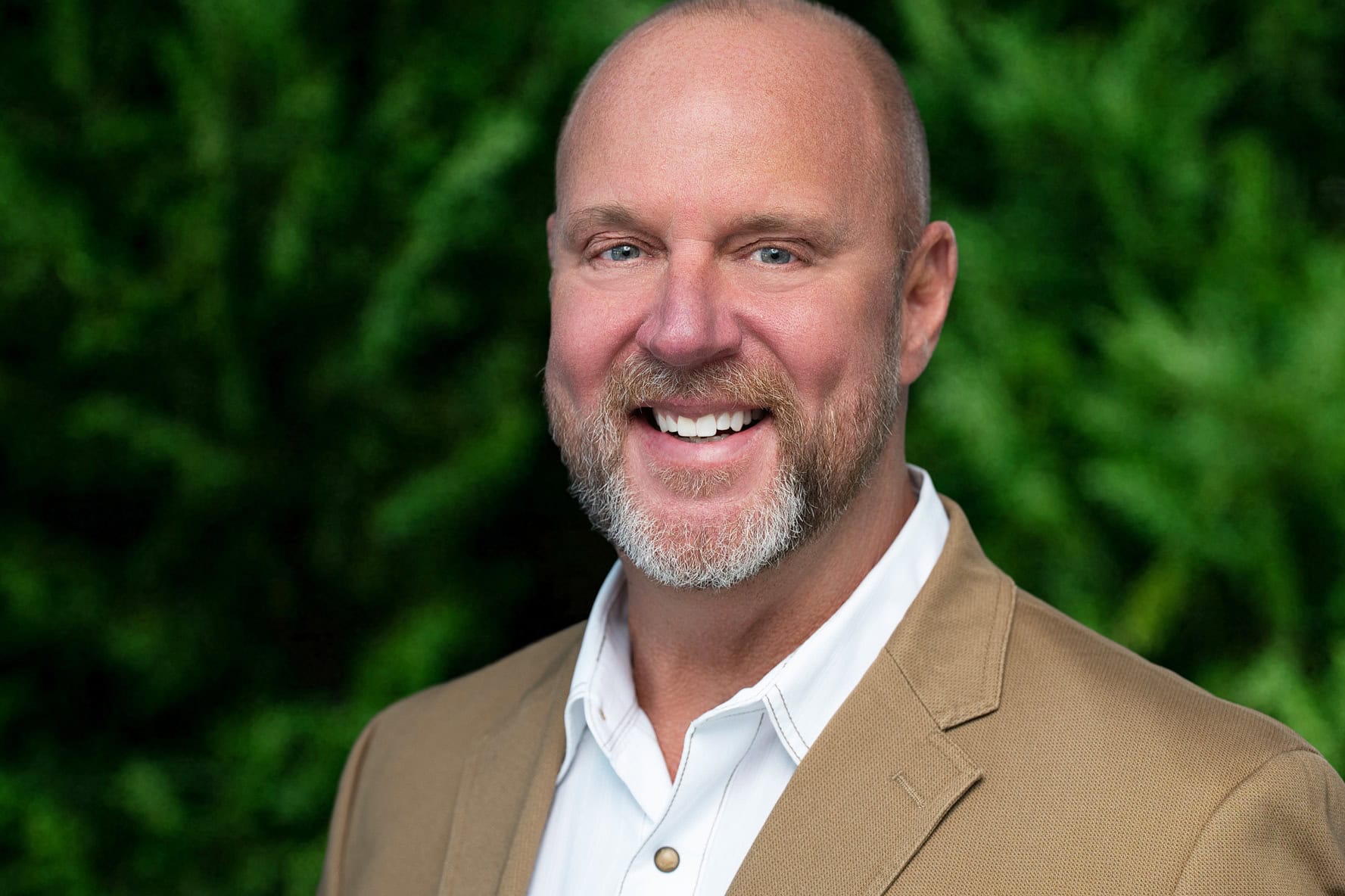 Director of Construction headshot in Tampa Bay with consistent greenery background for a construction company team