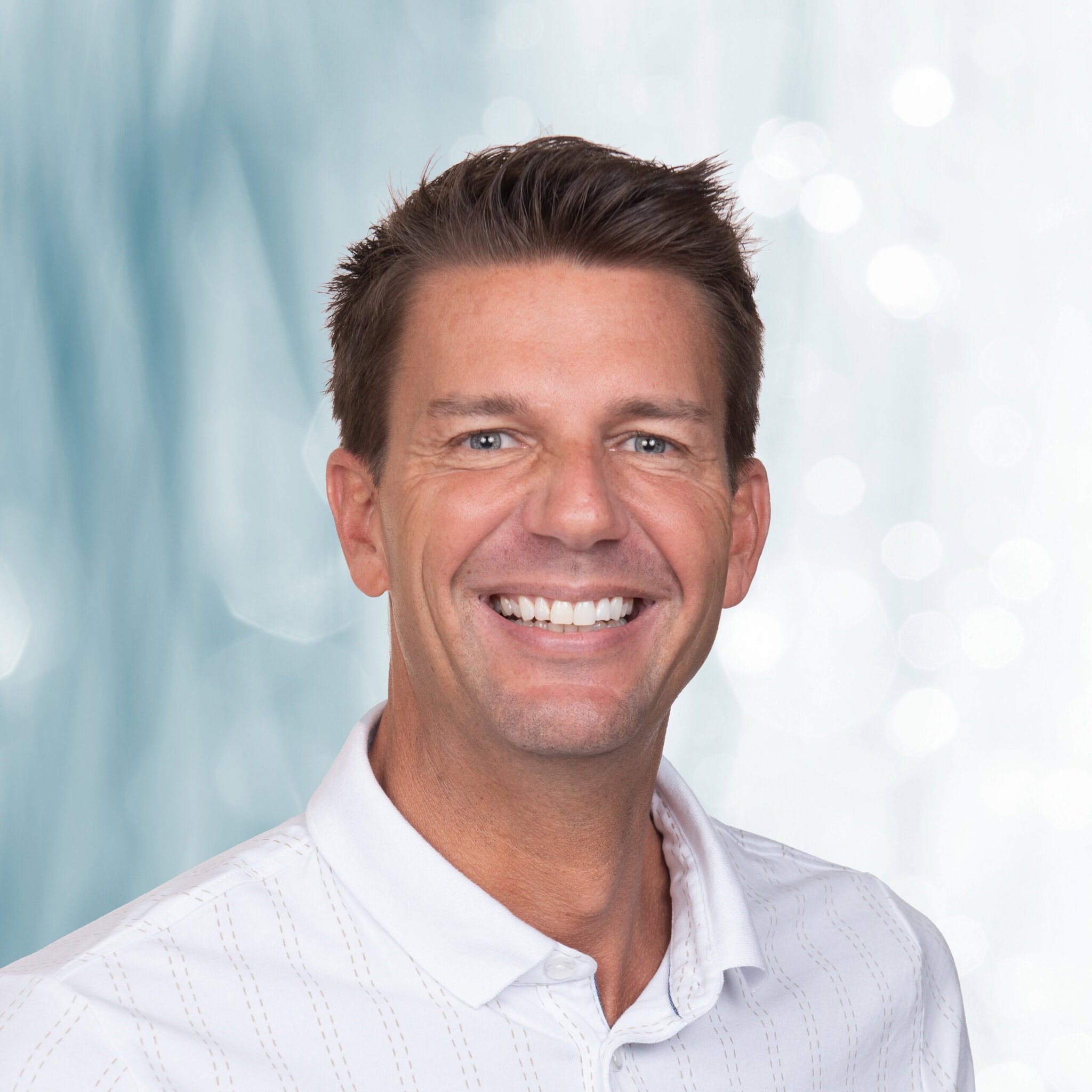 Male sales representative at Harrell's LLC with a composite green background, demonstrating clean hair masking and consistent corporate headshot lighting.