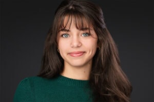 A captivating actor headshot of a woman in a green top, demonstrating the range and coaching provided in a full individual session in Lakeland by James Connell.