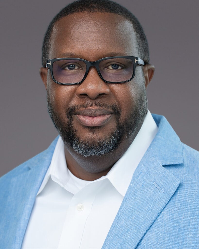 A professional corporate headshot of a male executive in a blue blazer, captured on-location for a Lakeland company by James Connell.