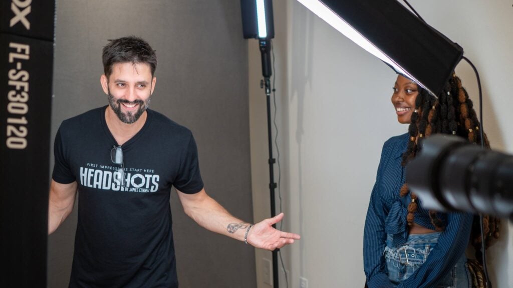 Photographer James Connell coaching a client's expression during a headshot session in his Ybor City studio in Tampa