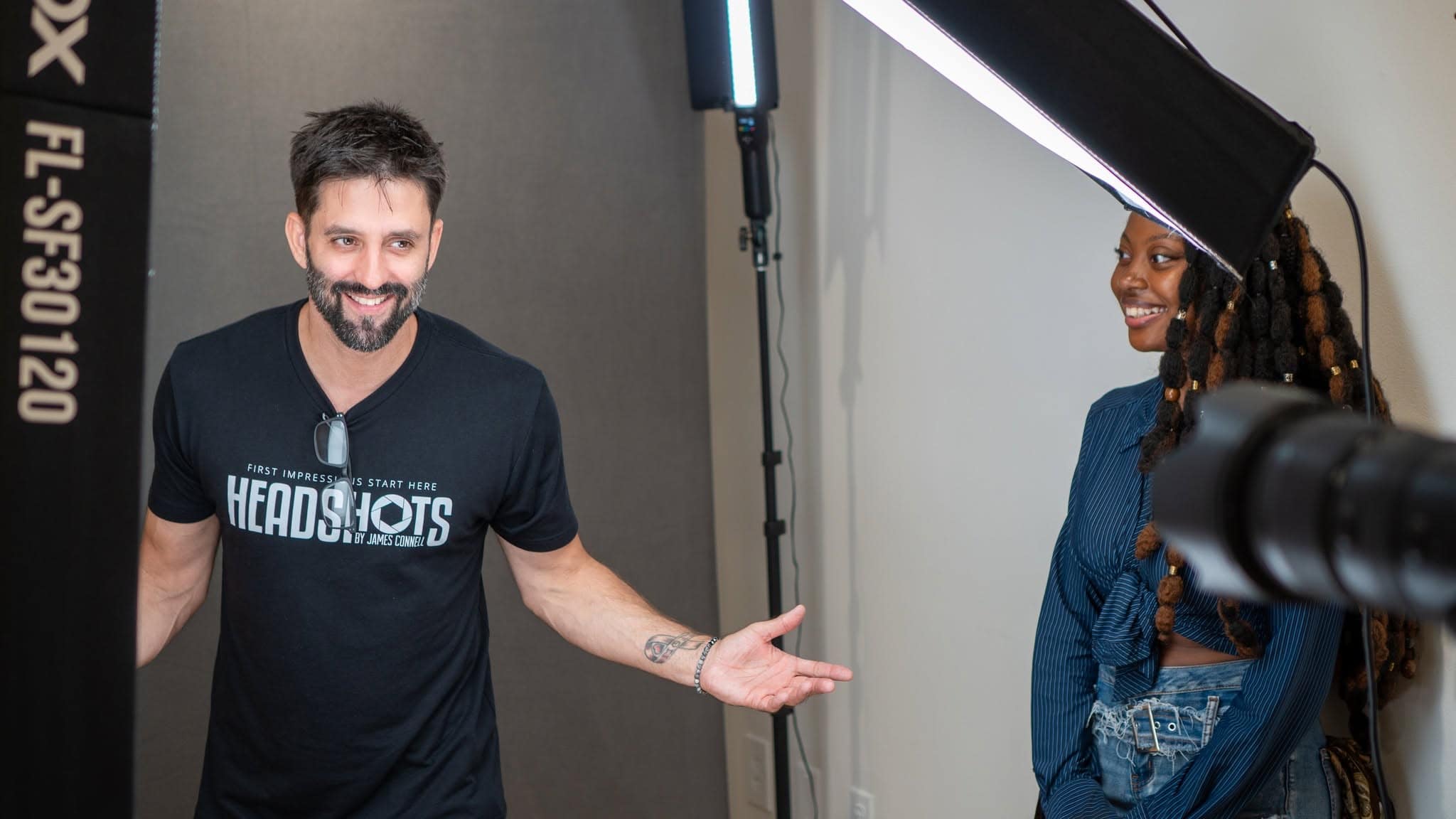 Photographer James Connell coaching a client's expression during a headshot session in his Ybor City studio in Tampa