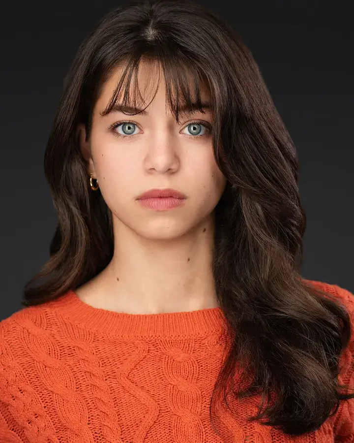 Actor headshot of a woman in an orange sweater, Tampa actor portrait