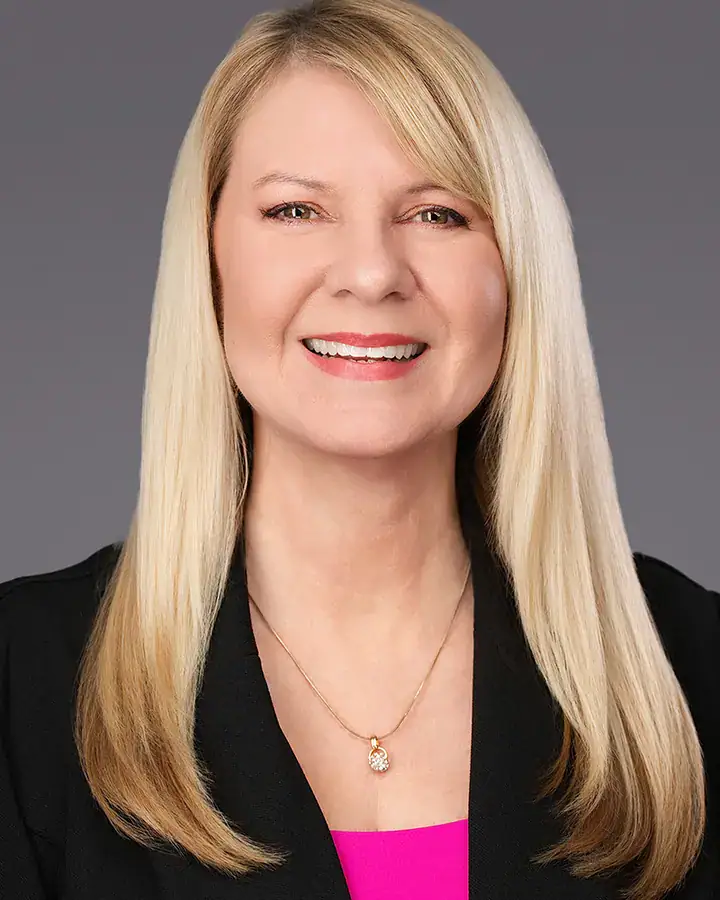 Corporate woman with blonde hair and a pink top, Tampa headshot