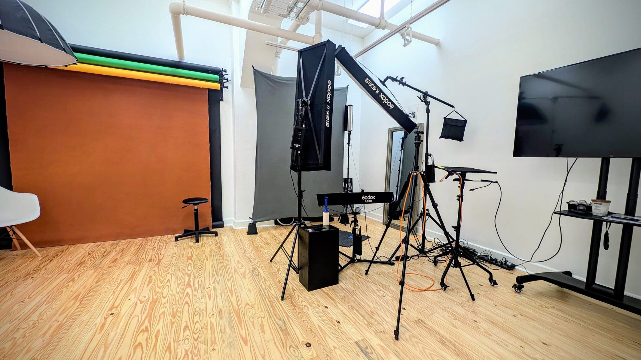 Headshot studio in Ybor City, Tampa, with lighting, backdrops and a large screen for live image review