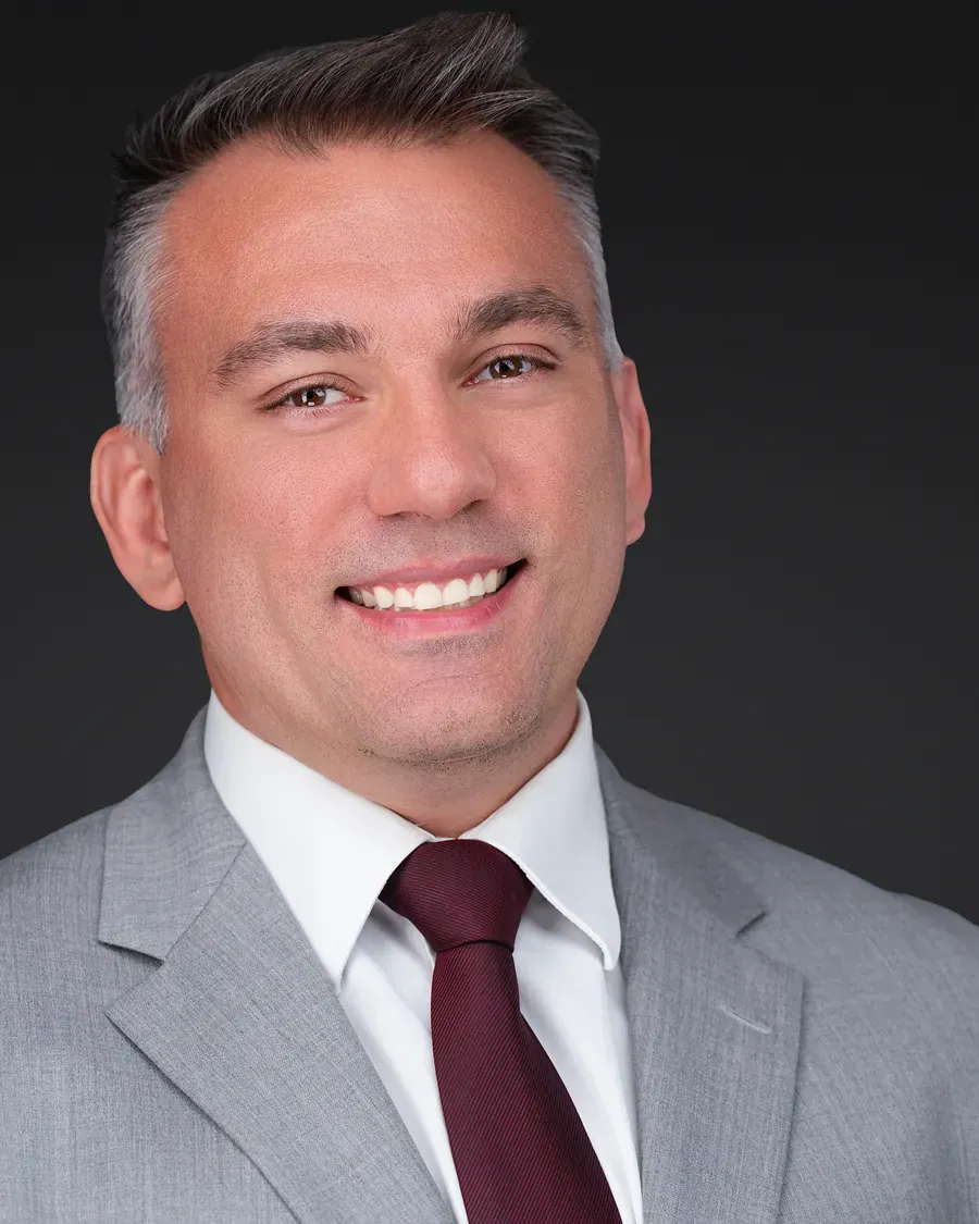Professional man in a gray suit and burgundy tie, Tampa headshot