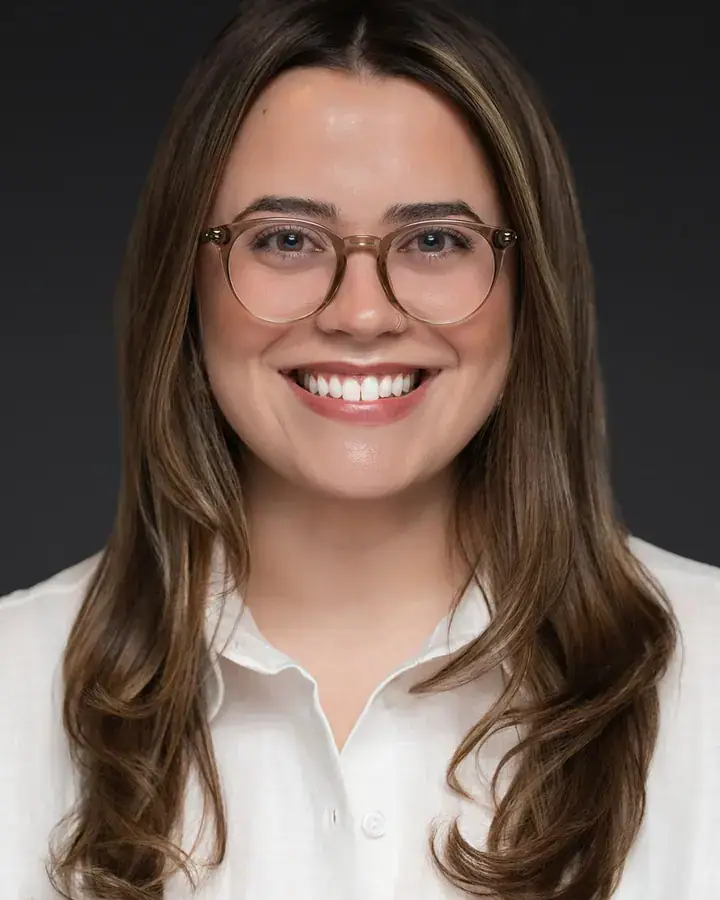 Professional woman with glasses in a cream blouse, Tampa headshot