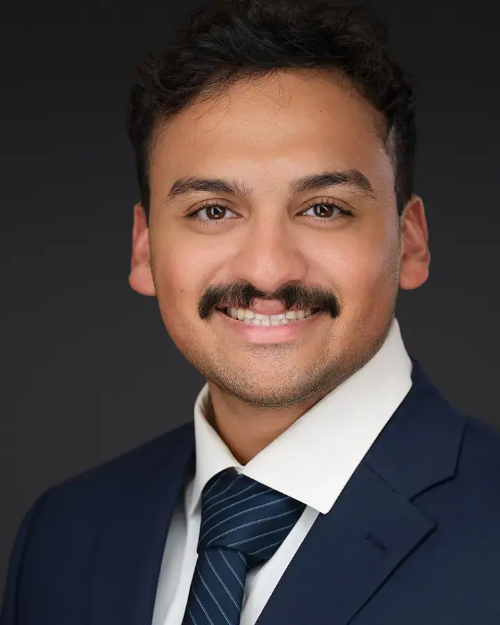 Professional man with a mustache in a navy suit, Tampa business headshot